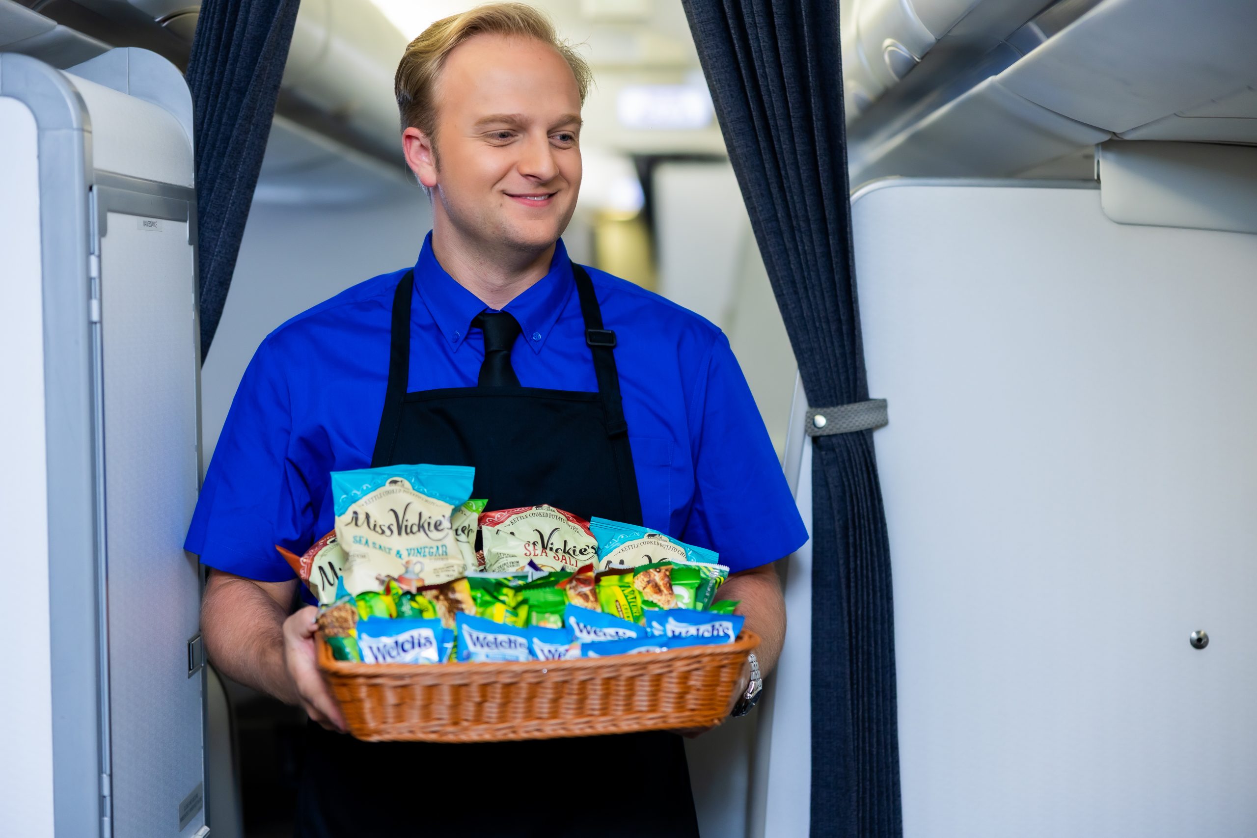 A flight attendant delivering snacks