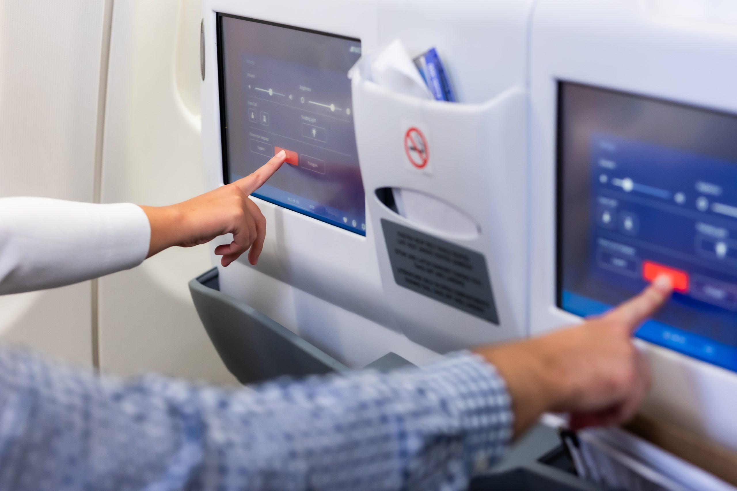 Airplane passengers interacting with their seat displays
