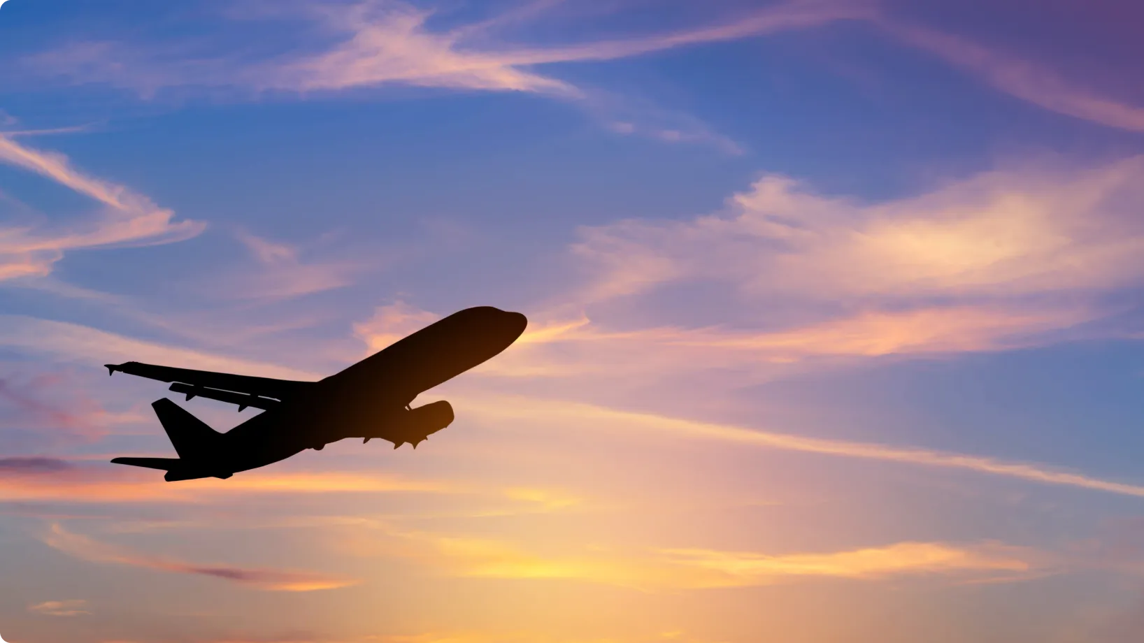 An airplane flying at dusk